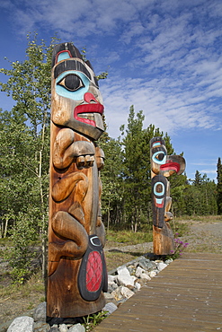 Totem poles with beaver image in the foreground, Teslin Tlingit Heritage Center, Teslin, Yukon, Canada, North America