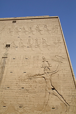 Relief depicting the Pharaoh slaying enemies, Pylon, Temple of Horus, Edfu, Egypt, North Africa, Africa