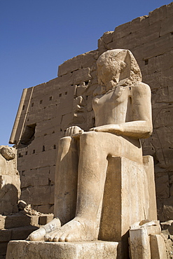 Seated Colossus in front of 8th Pylon, Karnak Temple, Luxor, Thebes, UNESCO World Heritage Site, Egypt, North Africa, Africa