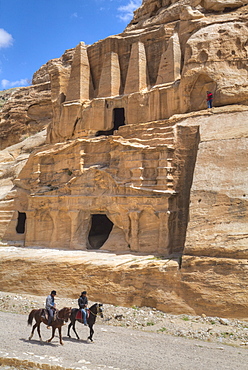 Local men on horses, Obelisk Tomb, upper structure, and Bab-as Siq Triclinium below, Petra, UNESCO World Heritage Site, Jordan, Middle East