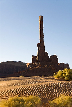 Early morning view of the Totem Pole with sand dunes in the foreground, Monument Valley, Utah, United States of America, North America