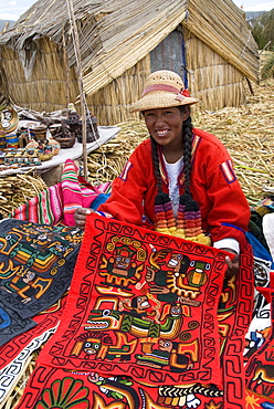 Local Uros woman selling handmade weaving, floating islands of the Uros, Lake Titicaca, Peru, South America