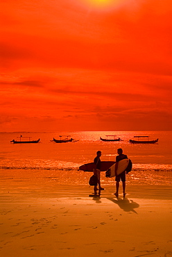 Two surfers late in the day, Kuta Beach, Bali, Indonesia, Southeast Asia, Asia