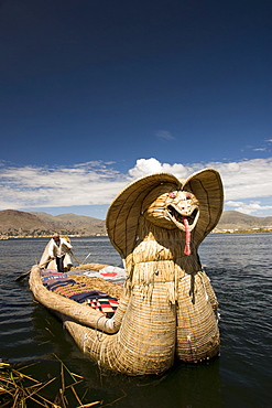 Reed boat with decorative bow, amid floating islands of the Uros people, Lake Titicaca, Peru, South America