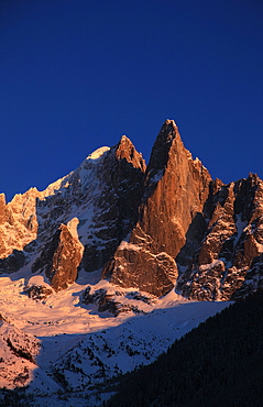 The celebrated peak of the Aiguille du Dru stands high above the village of Argentiere, Chamonix Valley, Chamonix, Haute Savoie, French Alps, France, Europe