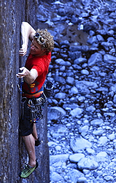 A climber tackles a sheer face using tiny fingerholds in Huntsman's Leap, near Bosherston and St. Govan's Head, Pembrokeshire Coast National Park, South Wales, Wales, United Kingdom, Europe