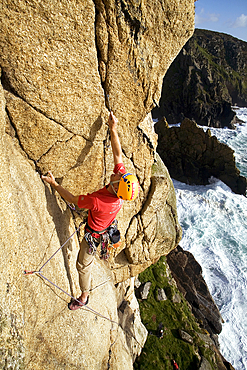 Rock climber in action at Bosigran, Cornwall, England, United Kingdom, Europe