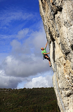 A climber tackles a steep and challenging route on the cliffs of the Aveyron Gorge, Aveyron region, Massif Central,  France