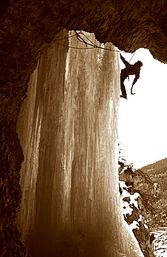 An ice climber scales a giant icicle in the valley of Crevoux, near Gap and Briancon, Ecrins Massif, western Alps, France