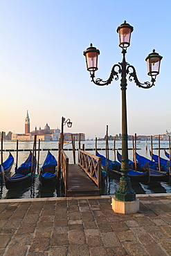 Gondolas moored on the Lagoon, San Giorgio Maggiore beyond, Riva degli Schiavoni, Venice, UNESCO World Heritage Site, Veneto, Italy, Europe