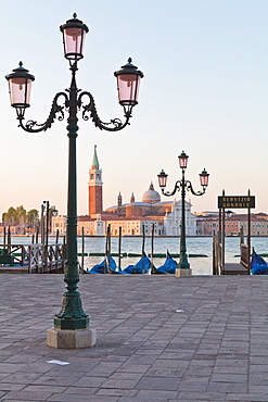 Gondolas moored on the Lagoon, San Giorgio Maggiore beyond, Riva degli Schiavoni, Venice, UNESCO World Heritage Site, Veneto, Italy, Europe