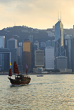 Chinese sailing junk on Victoria Harbour, the skyline of Central, Hong Kong Island beyond, Hong Kong, China, Asia