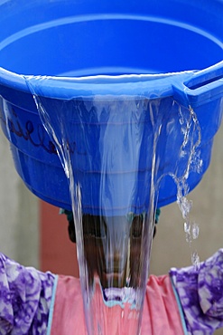 Woman pouring water, Popenguine, Thies, Senegal, West Africa, Africa