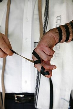 Rabbi putting on phylacteries, Paris, France, Europe