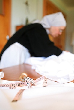 Benedictine nun making religious vestment, Urt, Pyrenees Atlantique, France, Europe