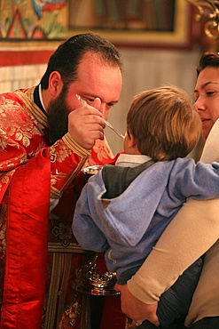 Greek Orthodox boy receiving the Eucharist, Thessaloniki, Macedonia, Greece, Europe