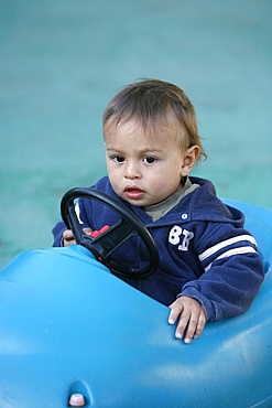 Baby in a toy car, France, Europe