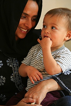 Veiled Muslim woman and child, France, Europe