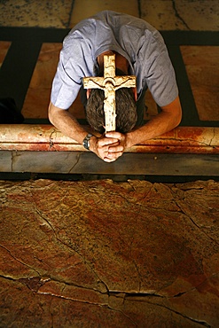 Worshipper at the Stone of the Anointing, Church of the Holy Sepulchre, Jerusalem, Israel, Middle East