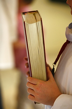 Altar boy carrying book, France, Europe