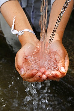 Child's hand with water, France, Europe