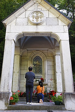 Couple praying at La Benite Fontaine sanctuary, La Roche-sur-Foron, Haute Savoie, France, Europe