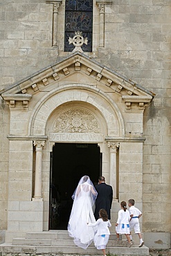 Bride walking into church, Montcalm, Gard, France, Europe