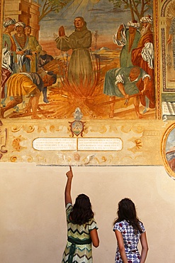 Mother and daughter looking at a fresco, Galatina, Lecce, Italy, Europe