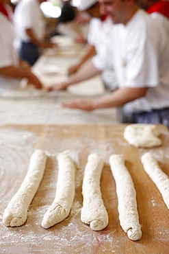 Bakers making loaves of bread (baguettes), Paris, France, Europe