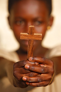 Young African Christian holding a cross, Lome, Togo, West Africa, Africa