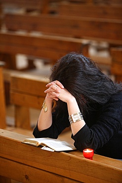 Woman praying in a church, Haute-Savoie, France, Europe