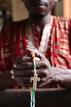 African man praying the rosary, Cotonou, Benin, West Africa, Africa