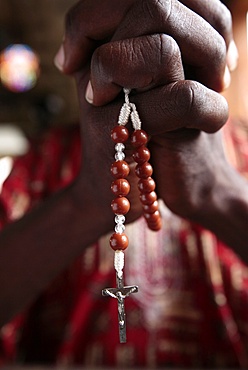 African man praying the rosary, Cotonou, Benin, West Africa, Africa