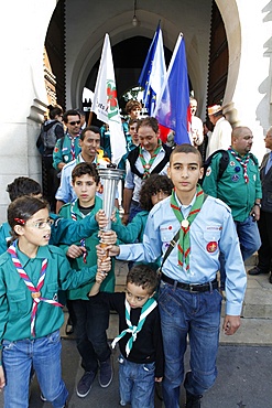 Muslim scouts coming out of the Paris Great Mosque carrying a torch, Paris, France, Europe