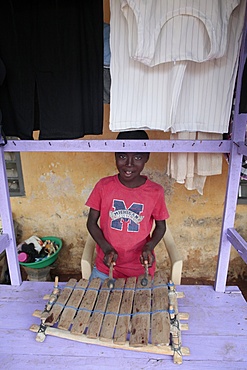 African boy playing music, Lome, Togo, West Africa, Africa