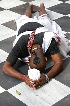 Hare Krishna devotee prostrating on the temple floor, Vrindavan, Uttar Pradesh, India, Asia