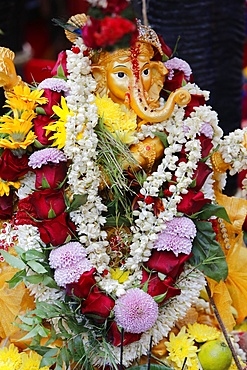 Statue of the Hindu God Ganesh with garlands, Paris, France, Europe