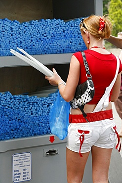 Irish woman buying candles at the Lourdes shrine, Lourdes, Hautes Pyrenees, France, Europe