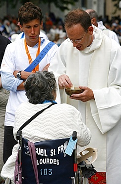 Disabled woman receiving Holy Communion, Lourdes, Hautes Pyrenees, France, Europe