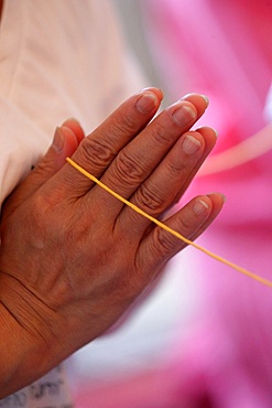 Sai-Sin (sacred thread) in use at a temple ceremony, International Buddhist Center of Geneva, Geneva, Switzerland, Europe