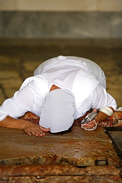 Worshipper at the Stone of the Anointing, Church of the Holy Sepulchre, Jerusalem, Israel, Middle East