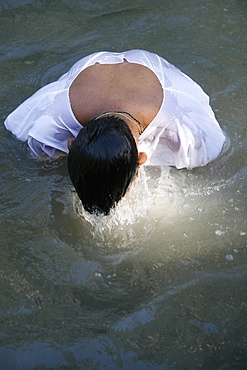 Christian pilgrim in Jordan River, Yardenit, Israel, Middle East