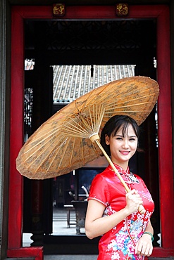 Woman wearing Vietnamese tradition dress called Ao Dai, Taoist temple, Phuoc An Hoi Quan Pagoda, Ho Chi Minh City, Vietnam, Indochina, Southeast Asia, Asia