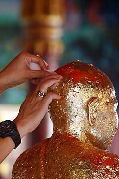 Faithful offering gold leaves, Khao Pansa celebration at Wat Ampharam, Hua Hin, Thailand, Southeast Asia, Asia