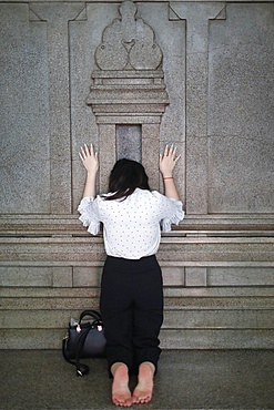 Worshipper praying at wall of the sanctuary, Mariamman Hindu Temple, Ho Chi Minh City, Vietnam, Indochina, Southeast Asia, Asia