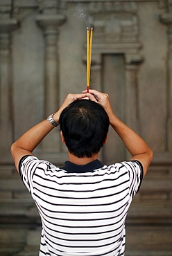 Worshipper praying at wall of the sanctuary, Mariamman Hindu Temple, Ho Chi Minh City, Vietnam, Indochina, Southeast Asia, Asia