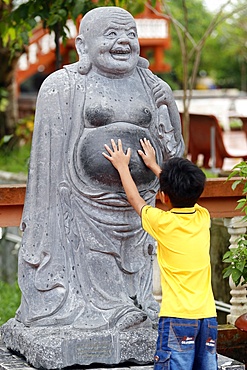 Truc Lam Phuong Nam Buddhist temple, small boy touching Angada statue, Can Tho, Vietnam, Indochina, Southeast Asia, Asia