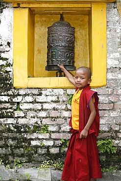 Young monk and prayer wheel, Swayambhunath temple, Kathmandu, Nepal, Asia