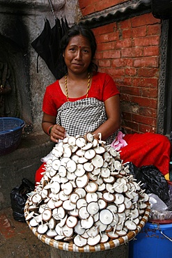 Woman selling butter lamps, Patan, Nepal, Asia