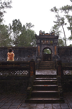 Tourist photographing Dai Hong Mon, Minh Mang Tomb, Hue, Vietnam, Indochina, Southeast Asia, Asia